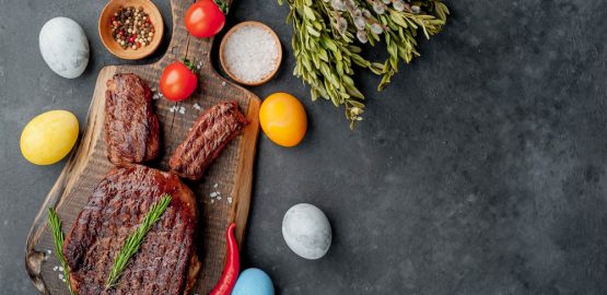 Slab of meat with Easter eggs surrounded around it