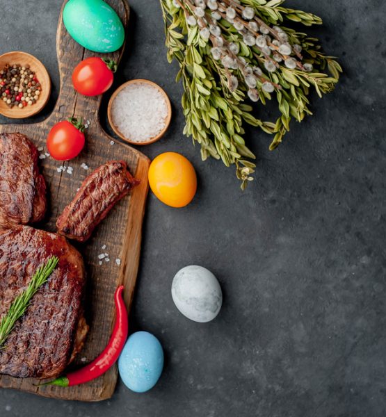 Slab of meat with Easter eggs surrounded around it